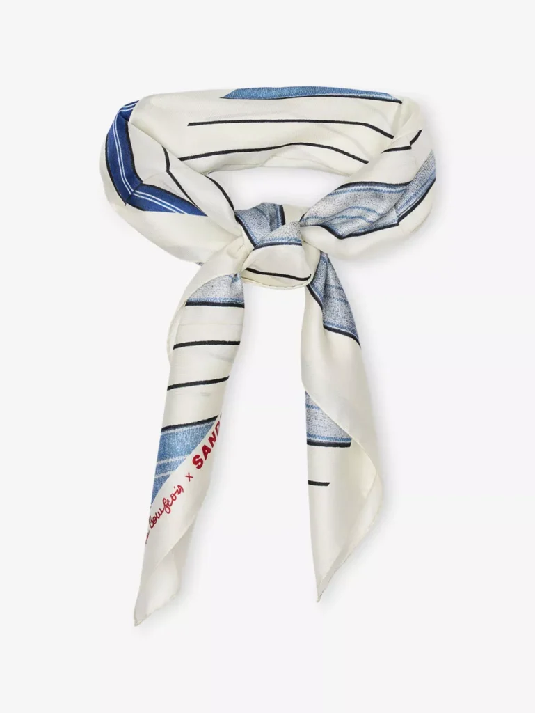White and blue silk square scarf by SANDRO with spiral and stripe print, styled in a loose knot
