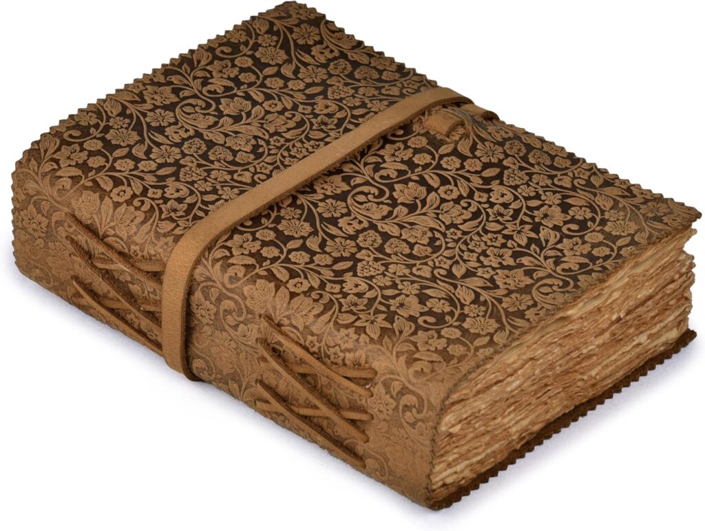 Ornate brown leather journal with floral embossing and tie closure — vintage-style notebook with handmade pages.