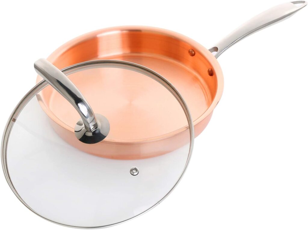 Pure copper frying pan with silver handle and matching glass lid, shown on white background.