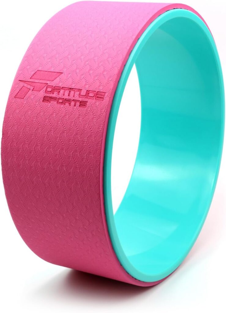 Pink Fortitude Sports yoga wheel with turquoise interior for enhanced stretching, back support, and flexibility training.