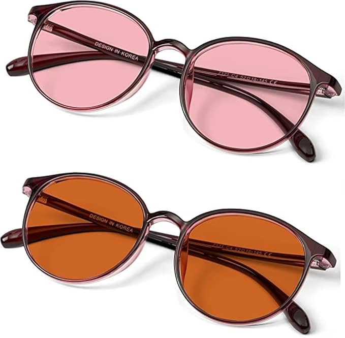Two pairs of round-lens BRADDELL OPTICS glasses in pink and amber tints designed for migraine and light sensitivity relief.