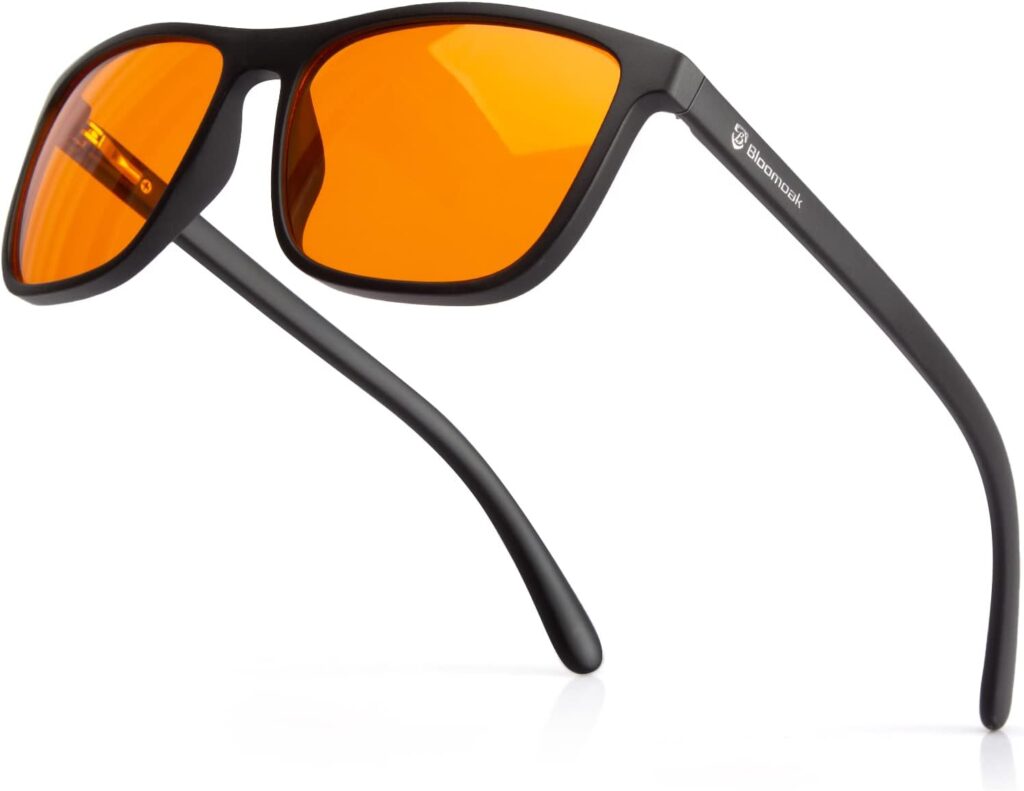 Close-up of Bloomoak amber-lens blue light blocking glasses with black frames designed for eye protection and screen fatigue relief.