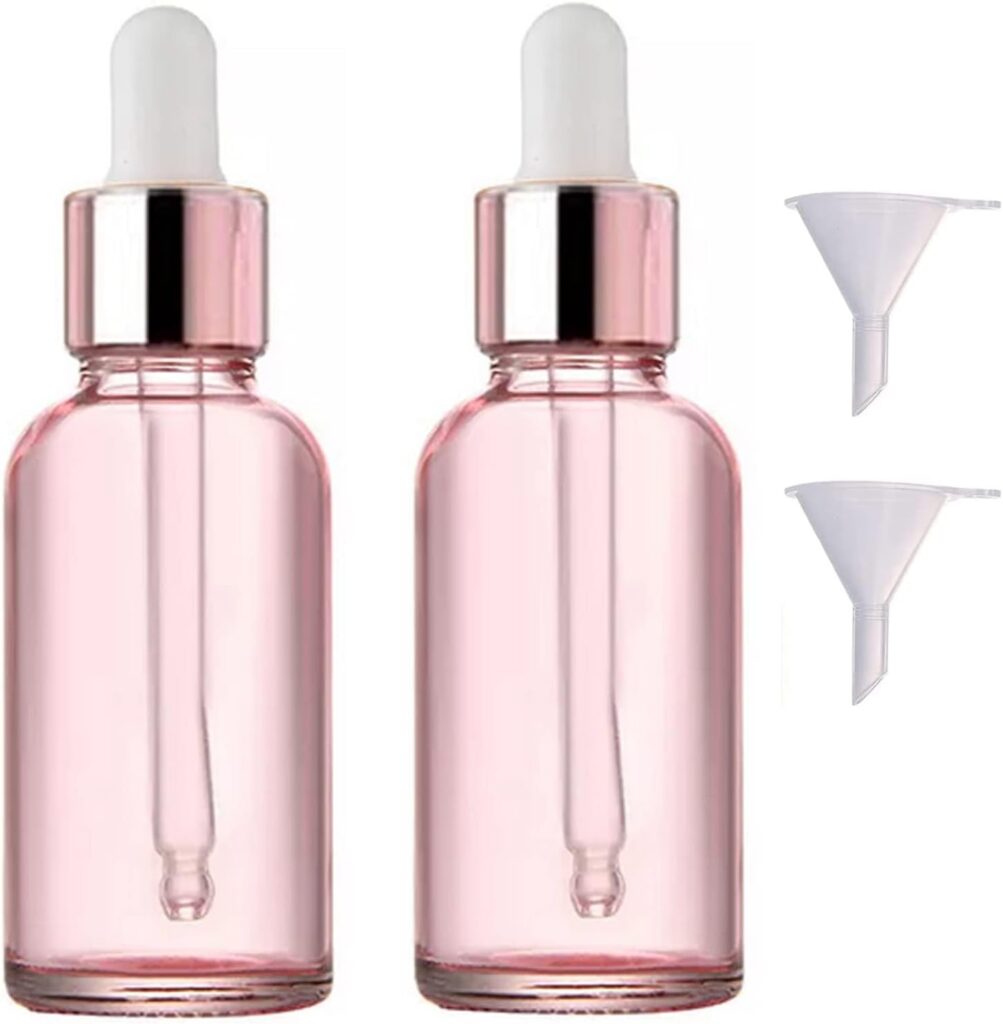 Pair of pink glass dropper bottles with white pipettes and mini funnels for serum or facial oil.