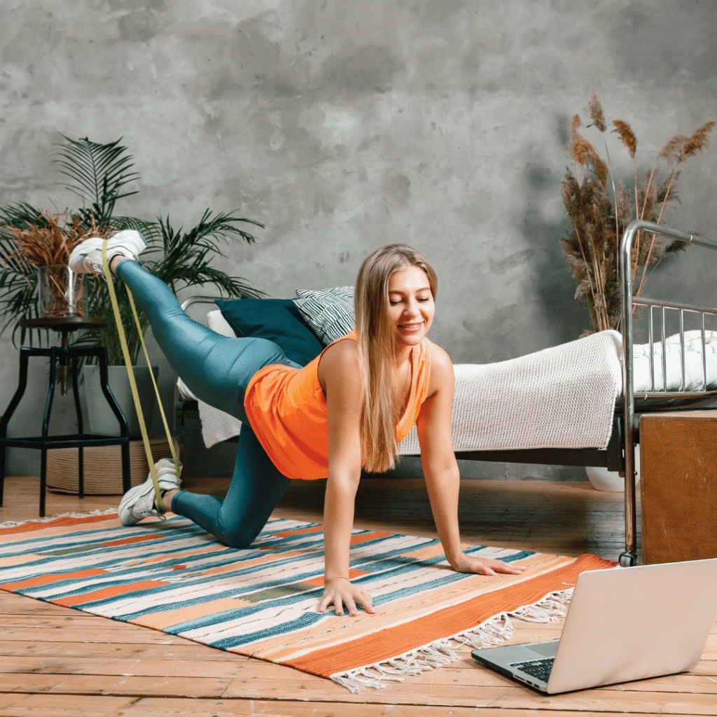 Woman doing resistance band glute workout at home with leg lifts – fitness while watching TV