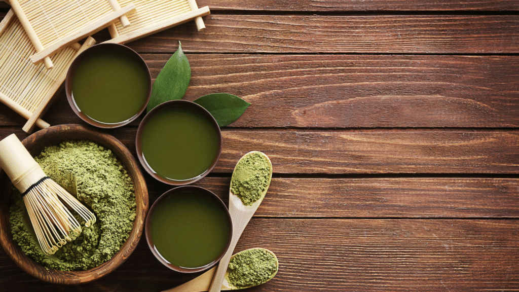 Powdered greens in small bowls and wooden spoons on rustic wooden table