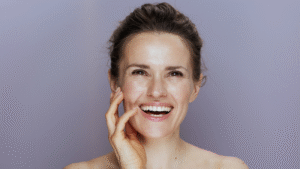 Smiling woman with radiant skin against a soft background, symbolising inner healing and collagen transformation